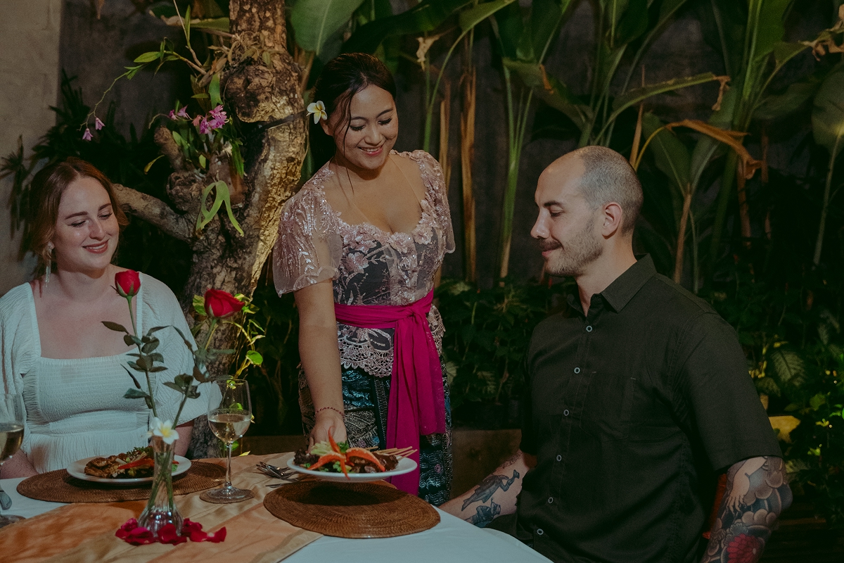 Guests enjoying drinks and a meal together at The Bidadari Villas & Spa