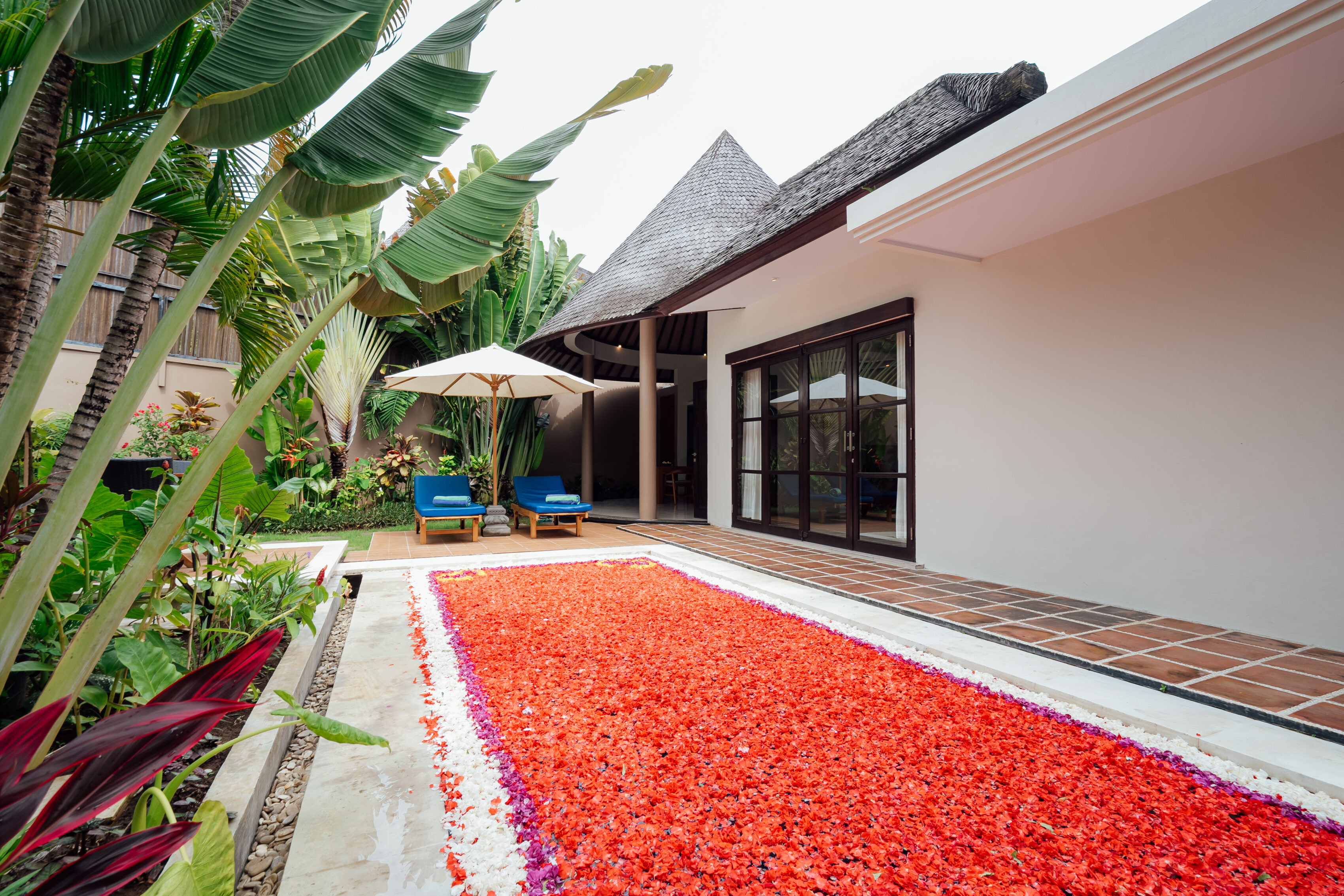 Heart of red rose petals on the terrace by a villa, romantic set-up at The Bidadari