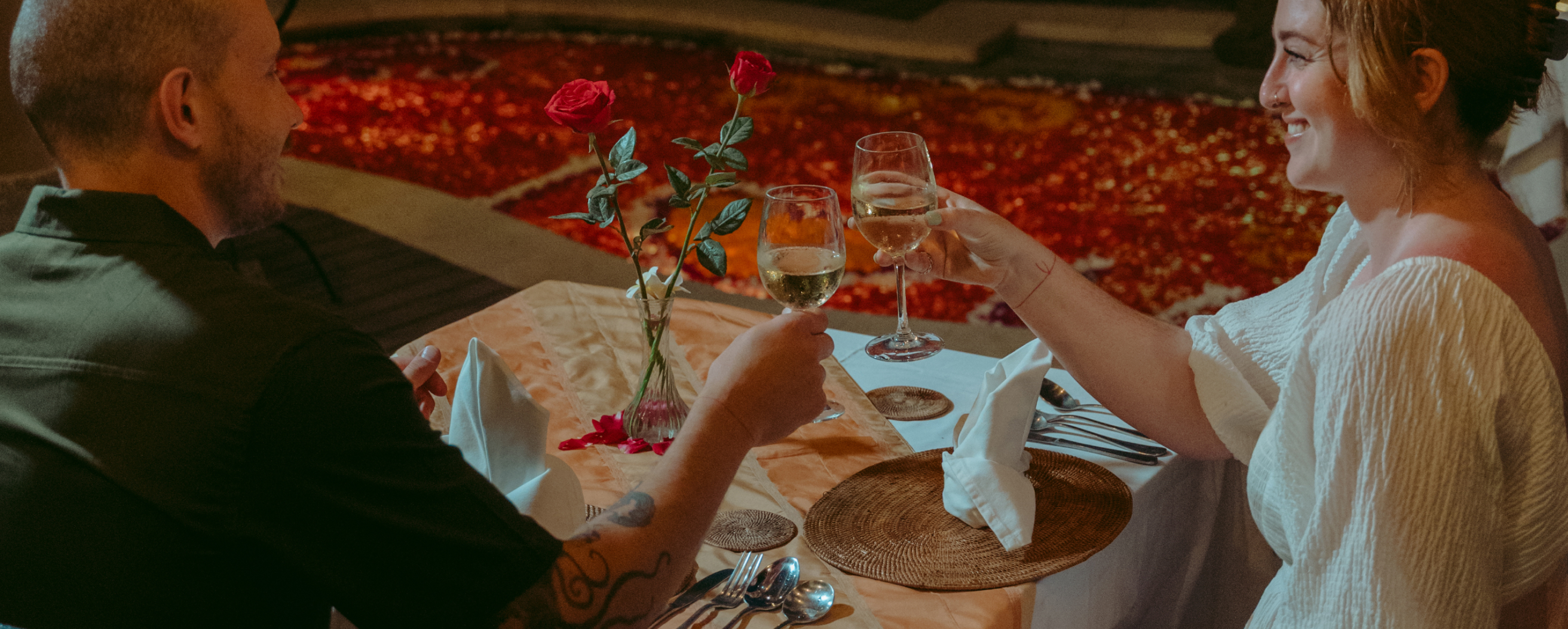 Romantic poolside dinner table with rose petals and candles, The Bidadari