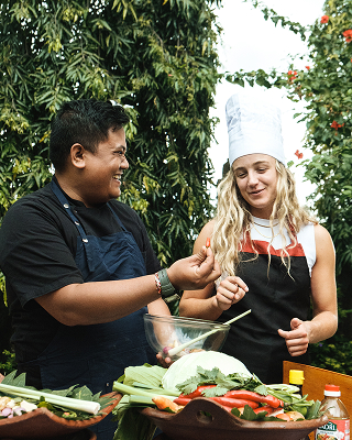 Chef and guest at an outdoor Balinese cooking class, The Bidadari Villas & Spa